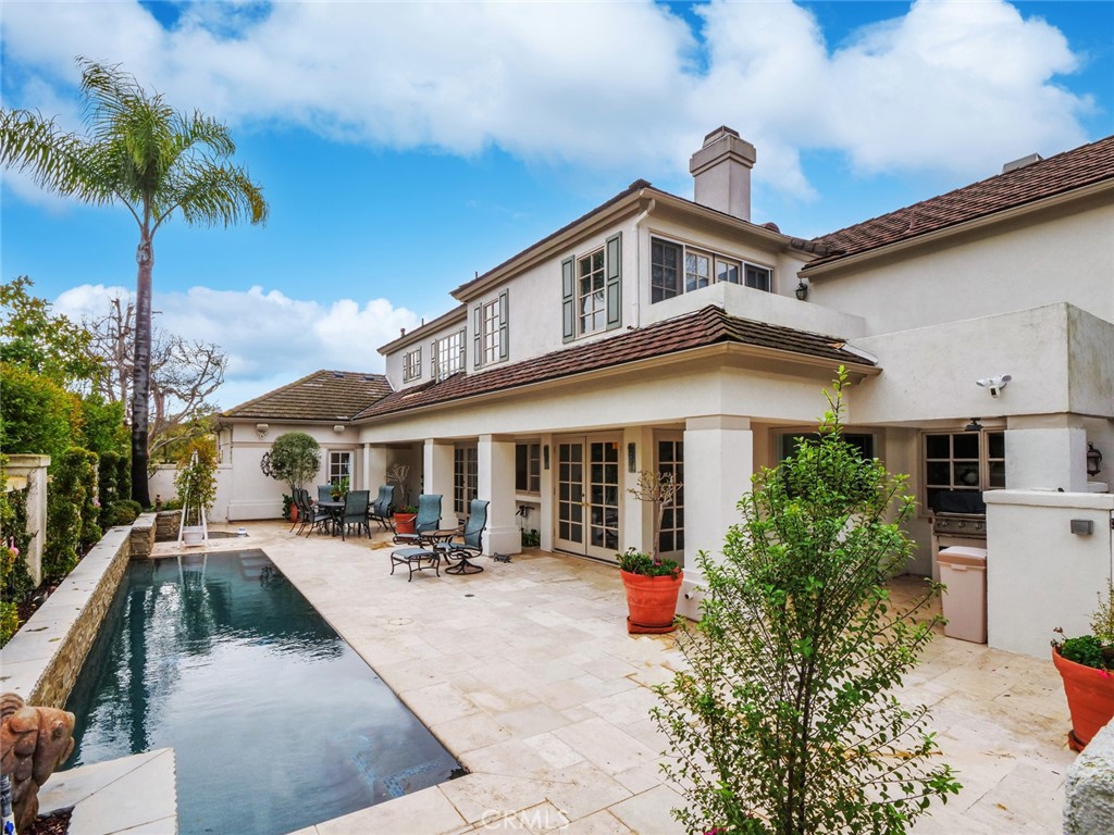 7 Hillcrest Meadows Rolling Hills Estates, CA 90274 - Photo 41 of 49 a view of a white house with a swimming pool and sitting area