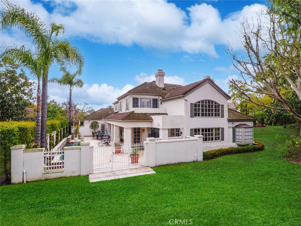 7 Hillcrest Meadows Rolling Hills Estates, CA 90274 - Photo 47 of 49 a front view of a house with a yard table and chairs