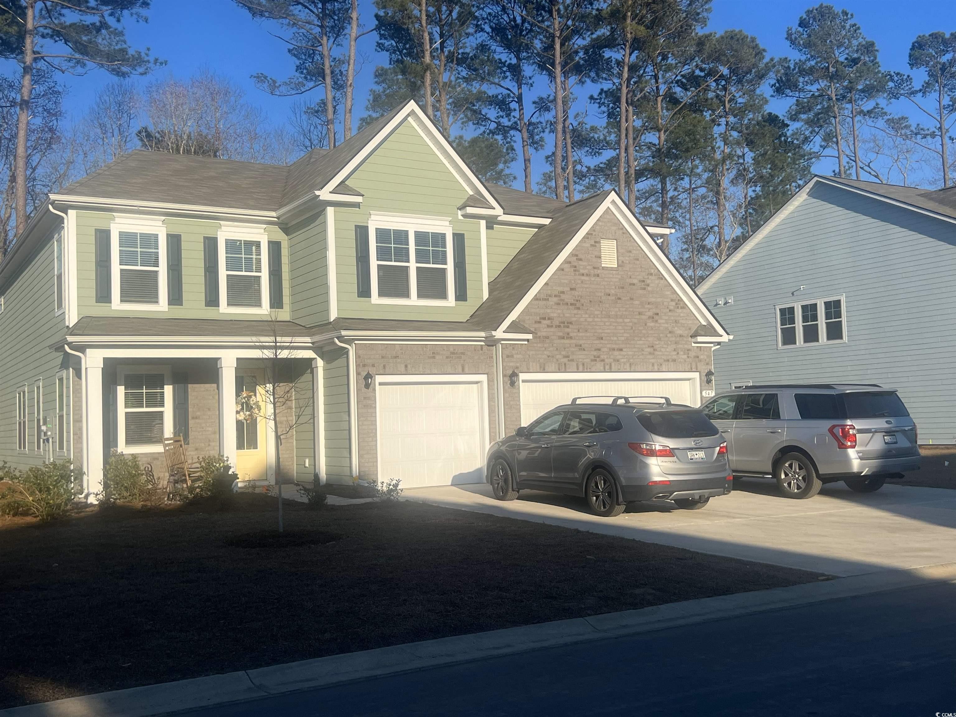 547 Haven View Way Murrells Inlet, SC 29576 - Photo 1 of 1 Traditional-style house with driveway and brick si