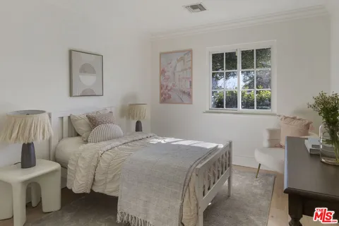 a bedroom with a bed and a table