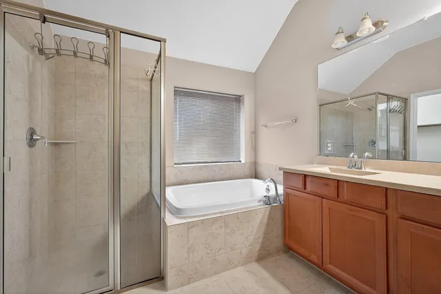a bathroom with a double vanity sink toilet and shower
