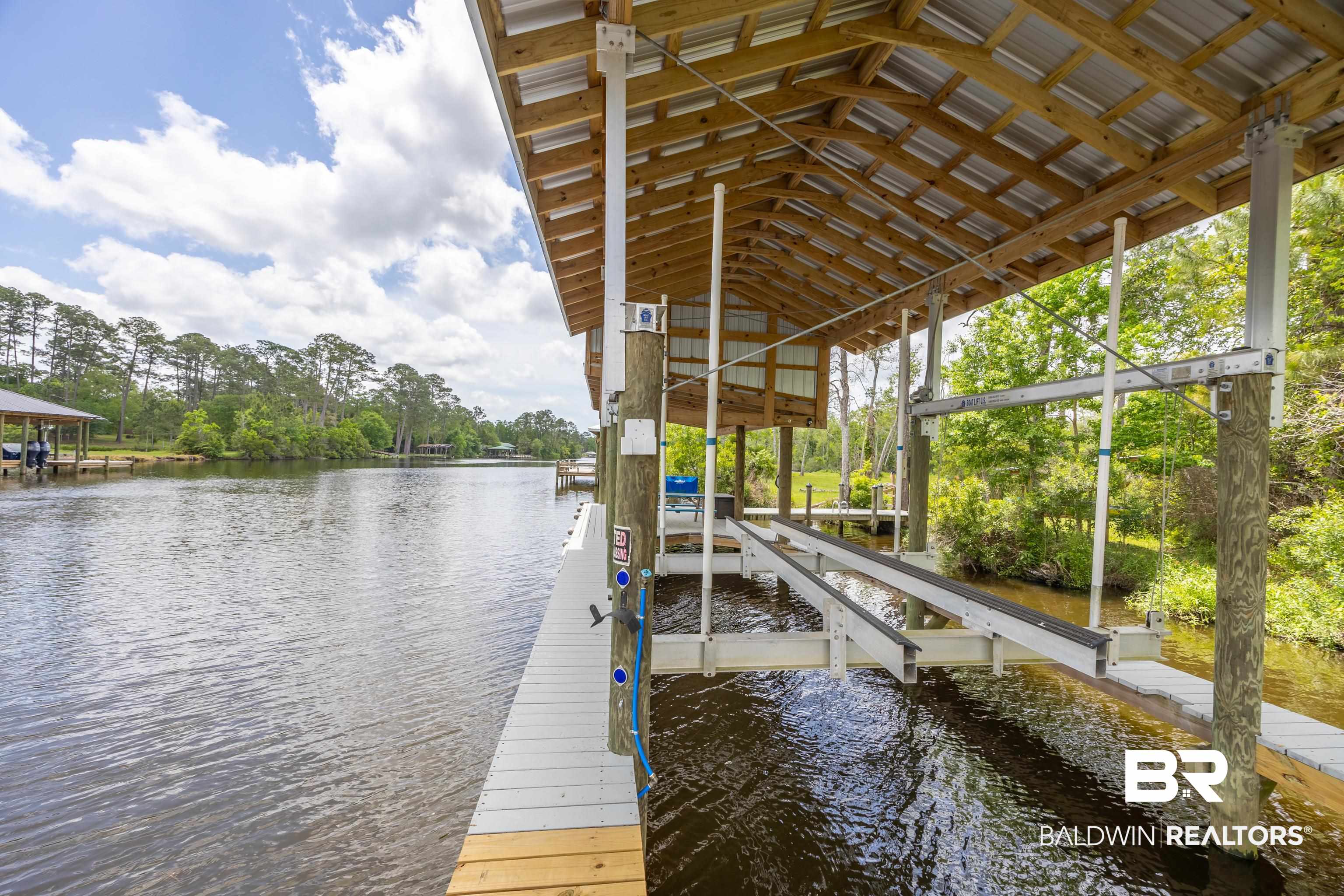9771 Clarke Ridge Road Foley, AL 36535 - Photo 16 of 72 View of dock with a water view and boat lift.