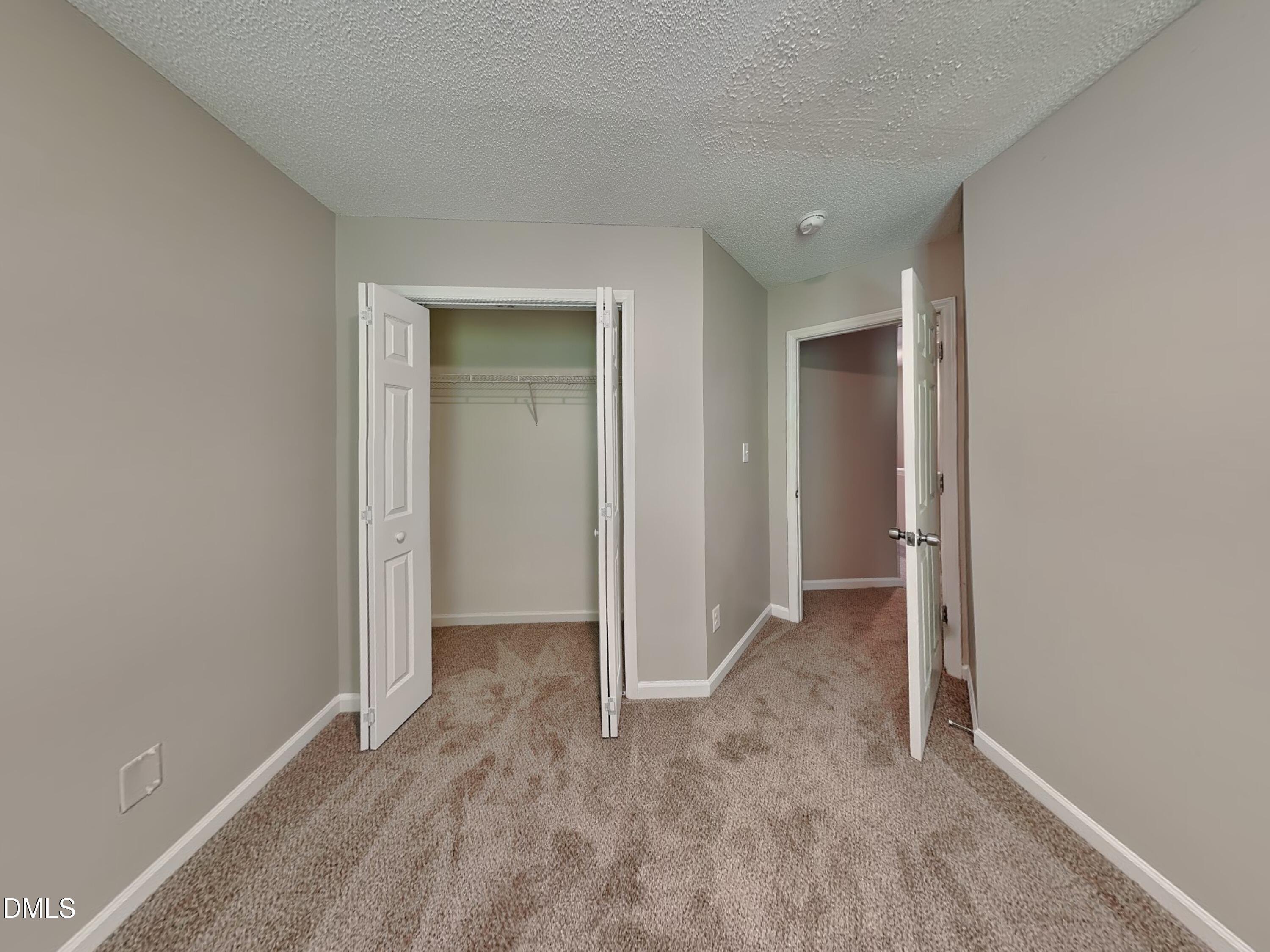 4409 Woodlawn Drive Raleigh, NC 27616 - Photo 12 of 15 an empty room with closet and a bathroom