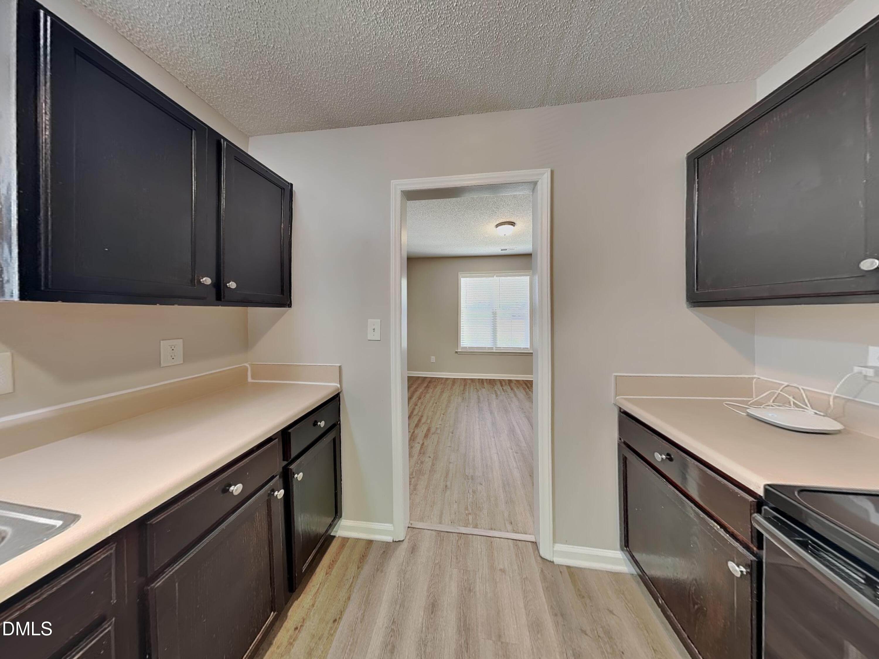 4409 Woodlawn Drive Raleigh, NC 27616 - Photo 5 of 15 a kitchen with a sink and cabinets
