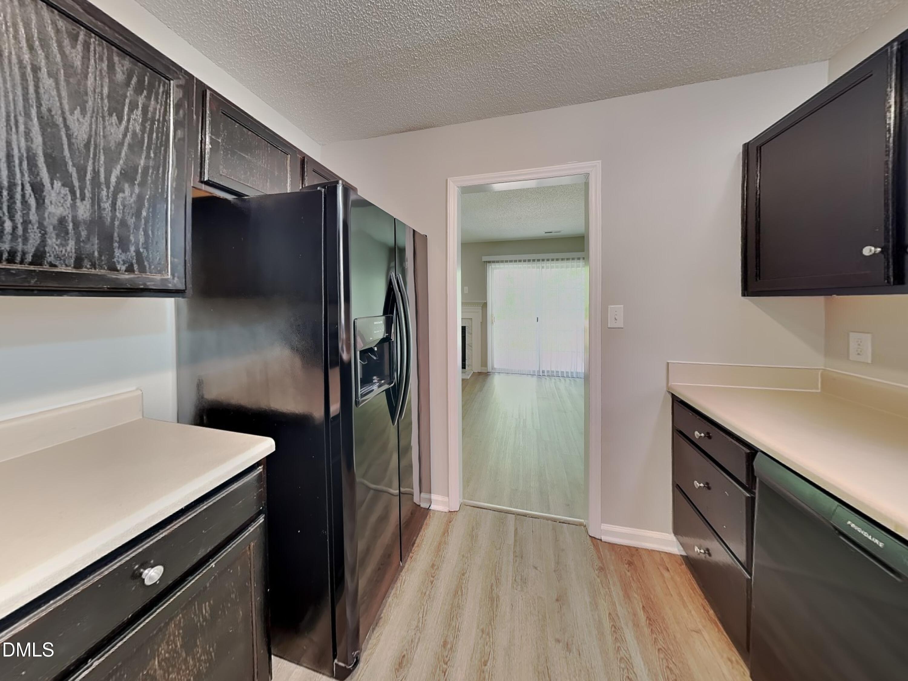 4409 Woodlawn Drive Raleigh, NC 27616 - Photo 6 of 15 a kitchen with a refrigerator and a sink