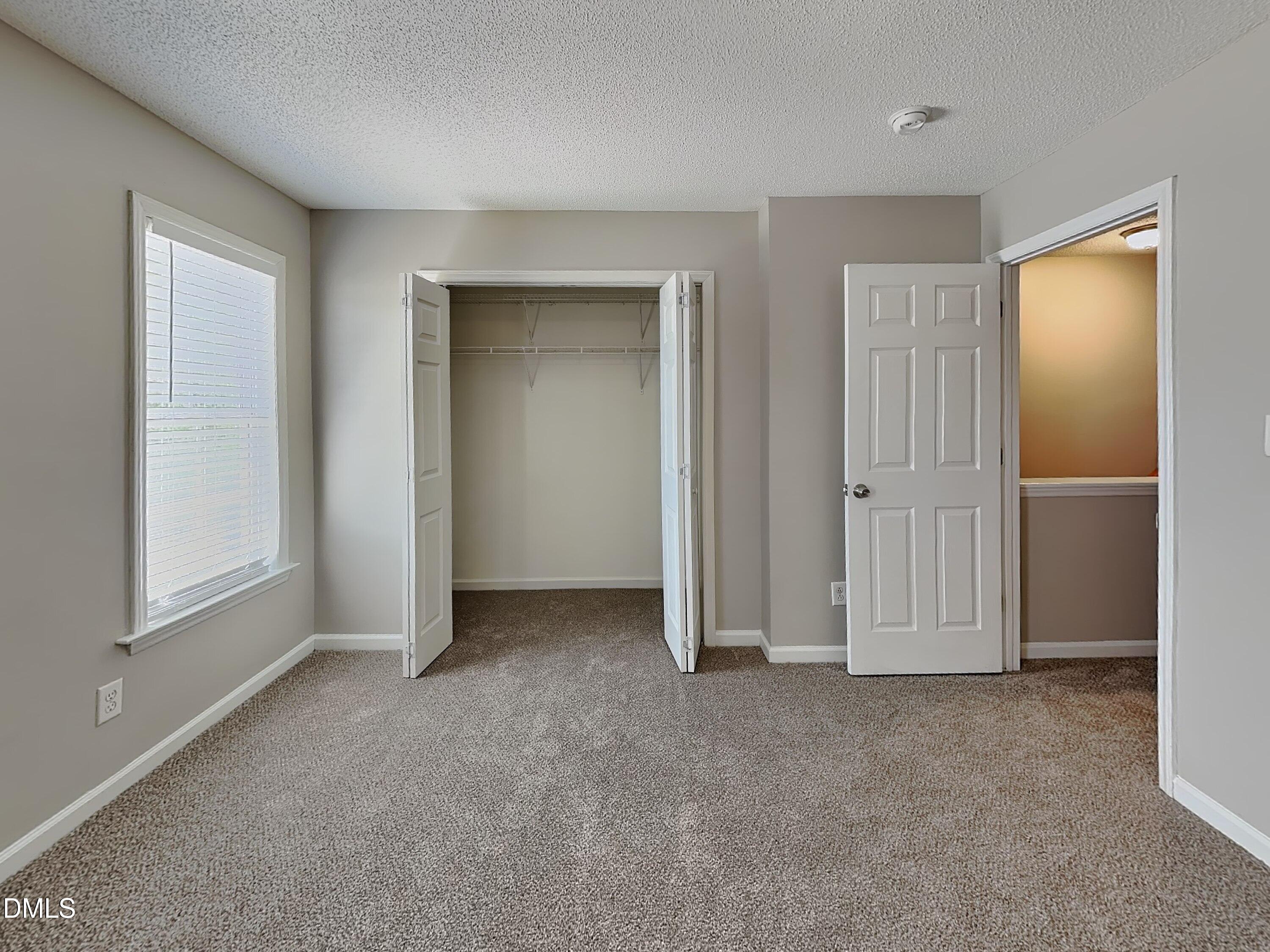 4409 Woodlawn Drive Raleigh, NC 27616 - Photo 7 of 15 an empty room with windows and closet