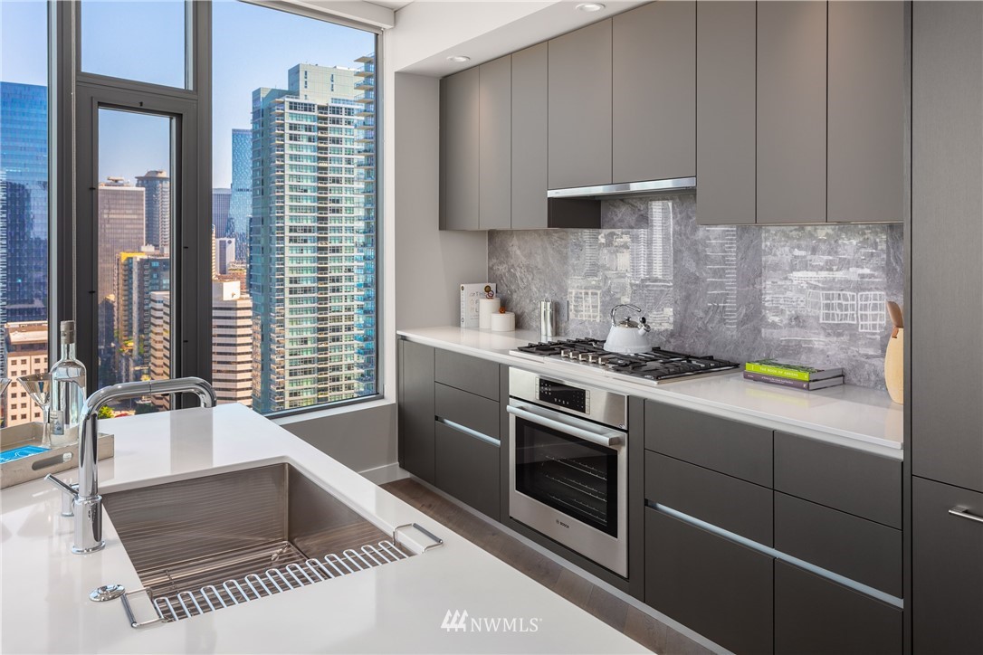 2510 6th Avenue, Unit 3502 Seattle, WA 98121 - Photo 11 of 38 a kitchen with stainless steel appliances granite countertop a sink stove and cabinets