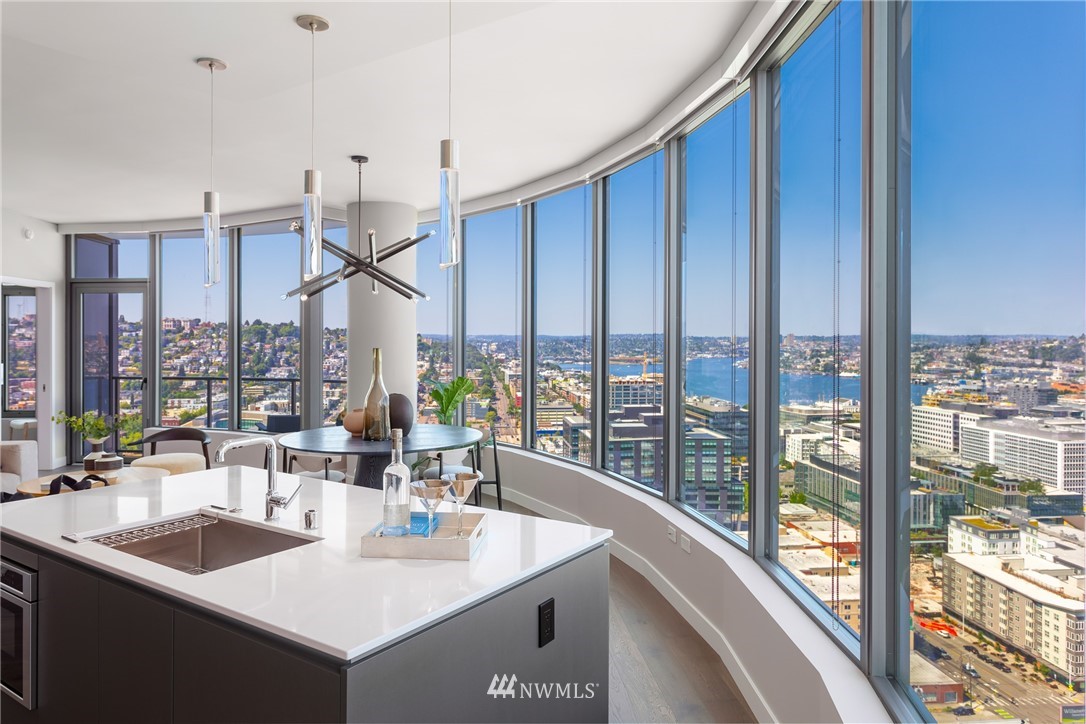 2510 6th Avenue, Unit 3502 Seattle, WA 98121 - Photo 14 of 38 a dining room with large windows and furniture