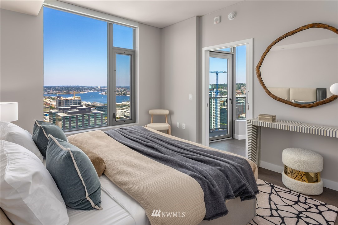 2510 6th Avenue, Unit 3502 Seattle, WA 98121 - Photo 18 of 38 a bedroom with a bed a mirror and a large window