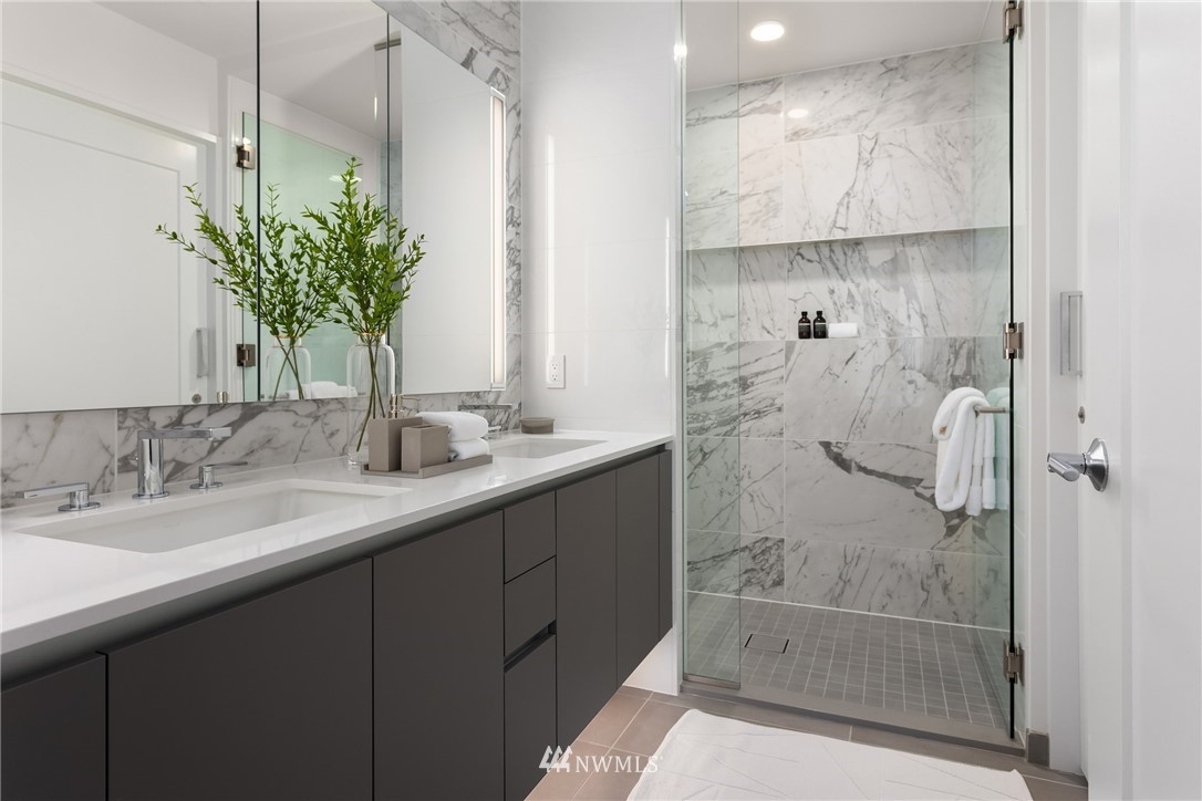 2510 6th Avenue, Unit 3502 Seattle, WA 98121 - Photo 20 of 38 a bathroom with a shower sink and mirror