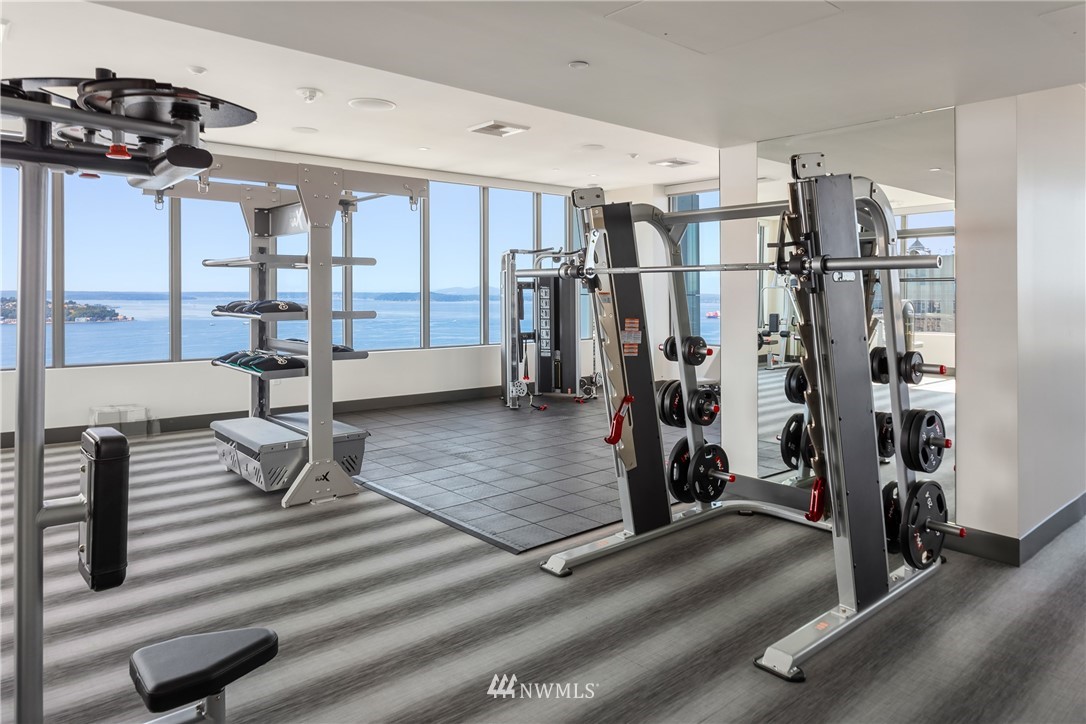 2510 6th Avenue, Unit 3502 Seattle, WA 98121 - Photo 24 of 38 a living room with lots of furniture and a gym equipment