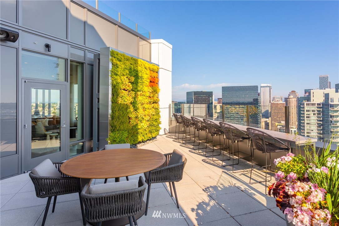 2510 6th Avenue, Unit 3502 Seattle, WA 98121 - Photo 31 of 38 a view of a balcony with table and chairs