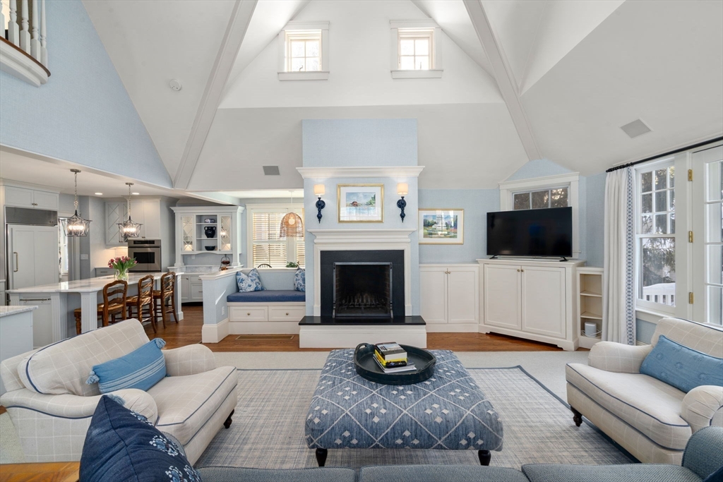29 Abbott Road Wellesley, MA 02481 - Photo 3 of 32 a living room with furniture a flat screen tv and a fireplace