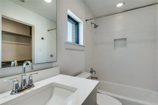 an empty room with a window and closet