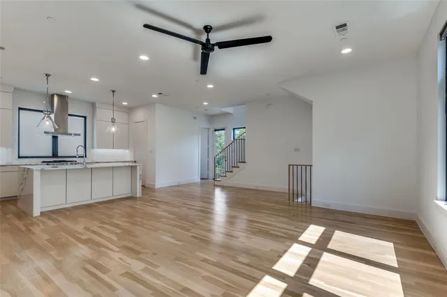 a large kitchen with kitchen island a sink stainless steel appliances and cabinets
