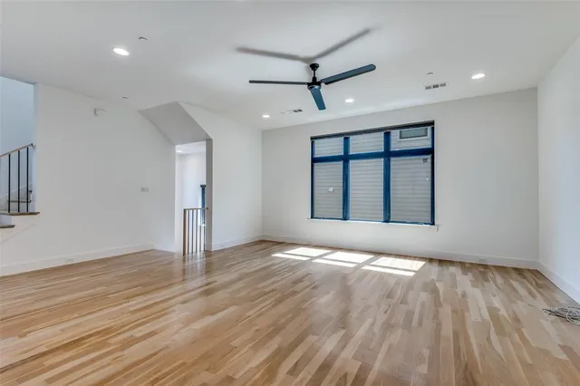 a view of a kitchen with wooden floor and a window