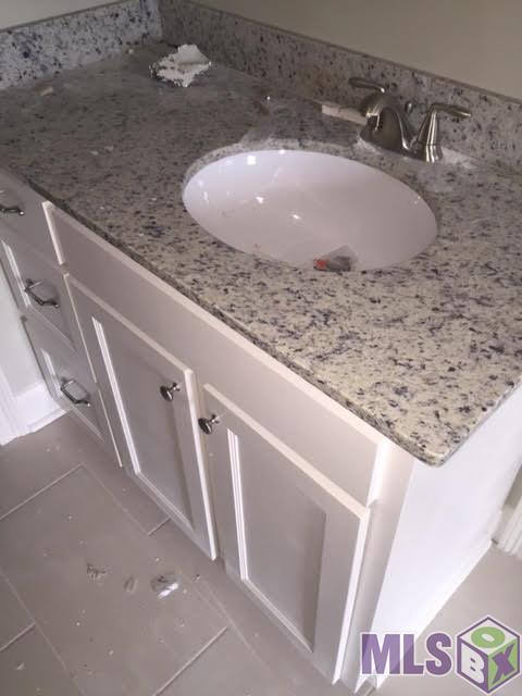 12474 Sims Road Denham Springs, LA 70706 - Photo 14 of 21 Slab granite and custom built cabinets