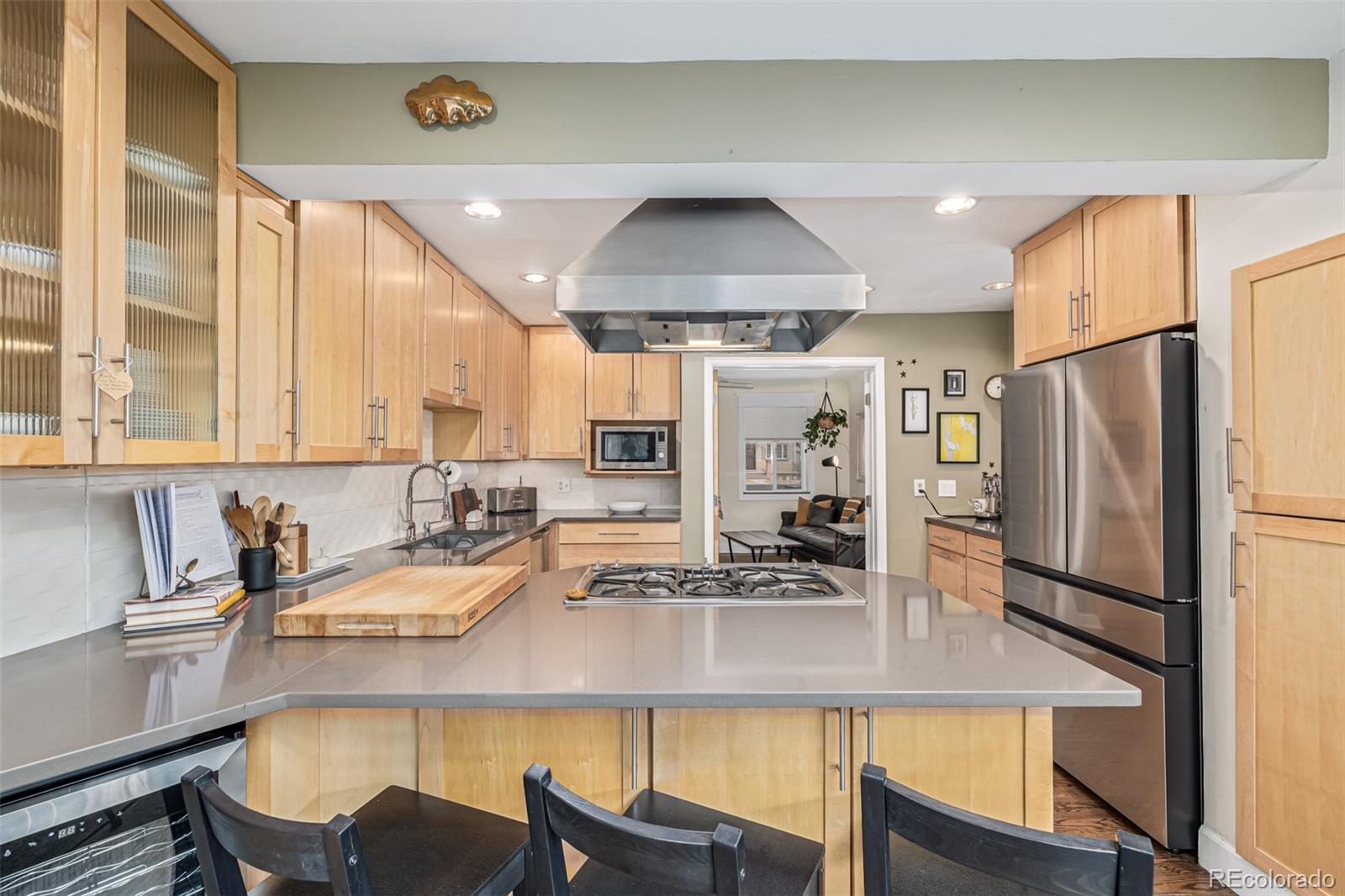 1227 Elm Street Denver, CO 80220 - Photo 11 of 44 a kitchen with a sink a refrigerator and chairs