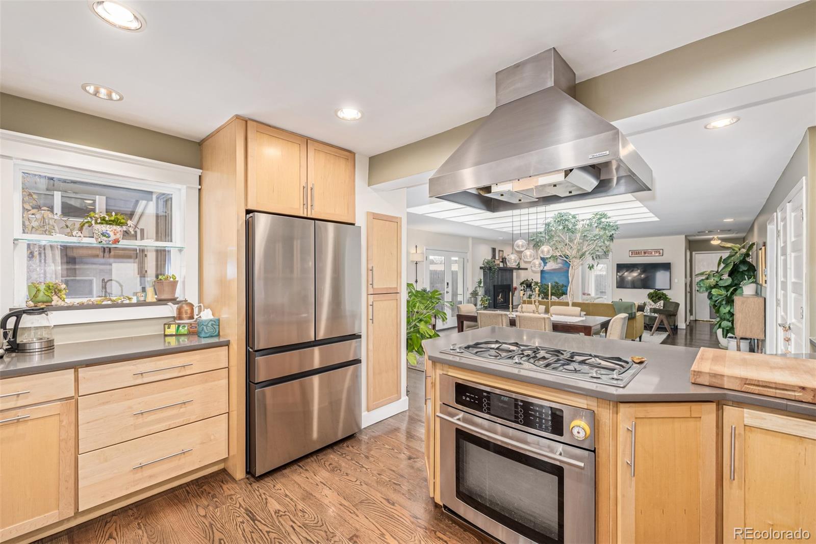 1227 Elm Street Denver, CO 80220 - Photo 12 of 44 a kitchen with stainless steel appliances granite countertop a stove a refrigerator and a sink