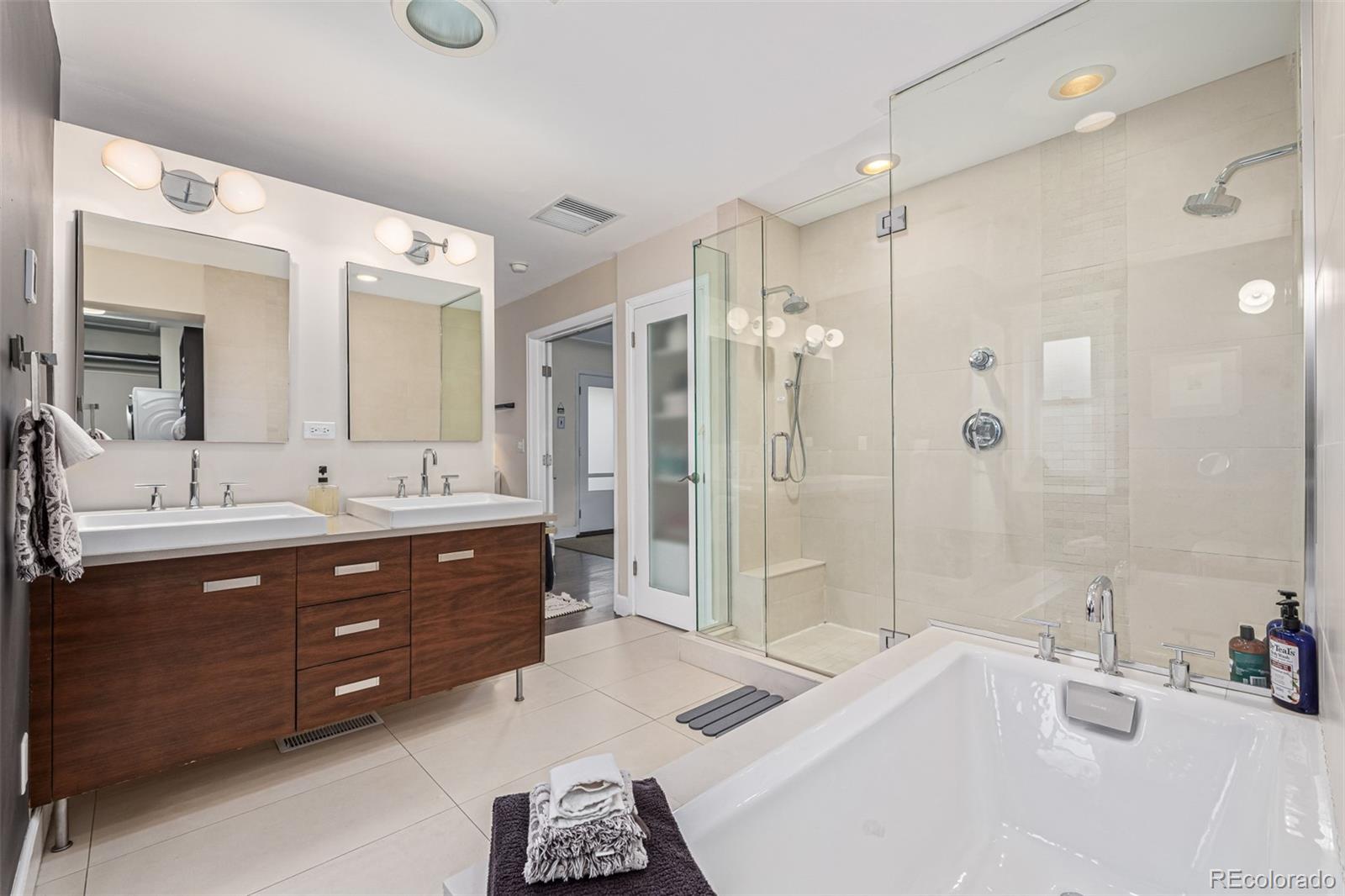 1227 Elm Street Denver, CO 80220 - Photo 16 of 44 a spacious bathroom with a tub sink mirror and shower