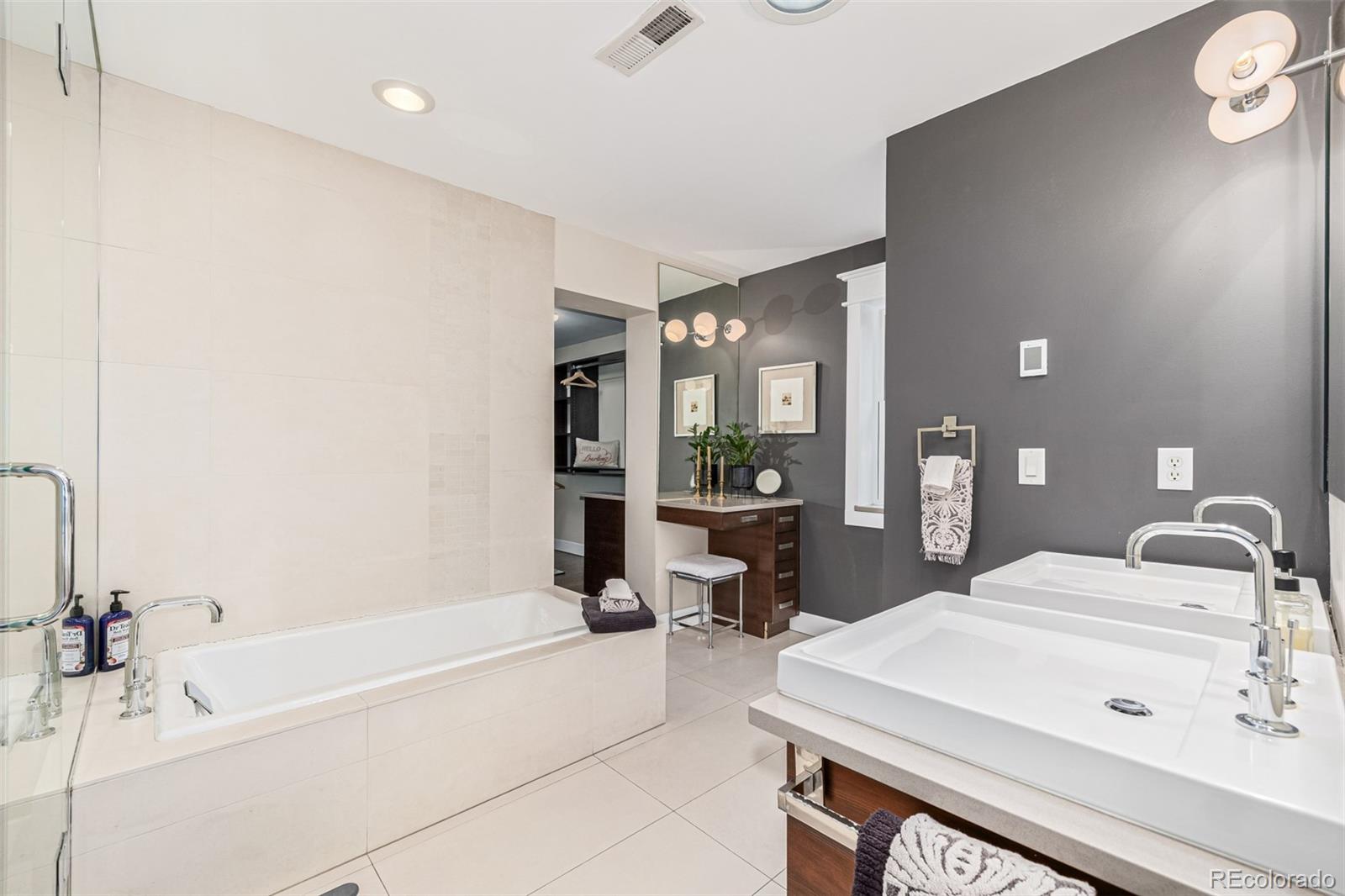 1227 Elm Street Denver, CO 80220 - Photo 17 of 44 a spacious bathroom with a bathtub and a sink