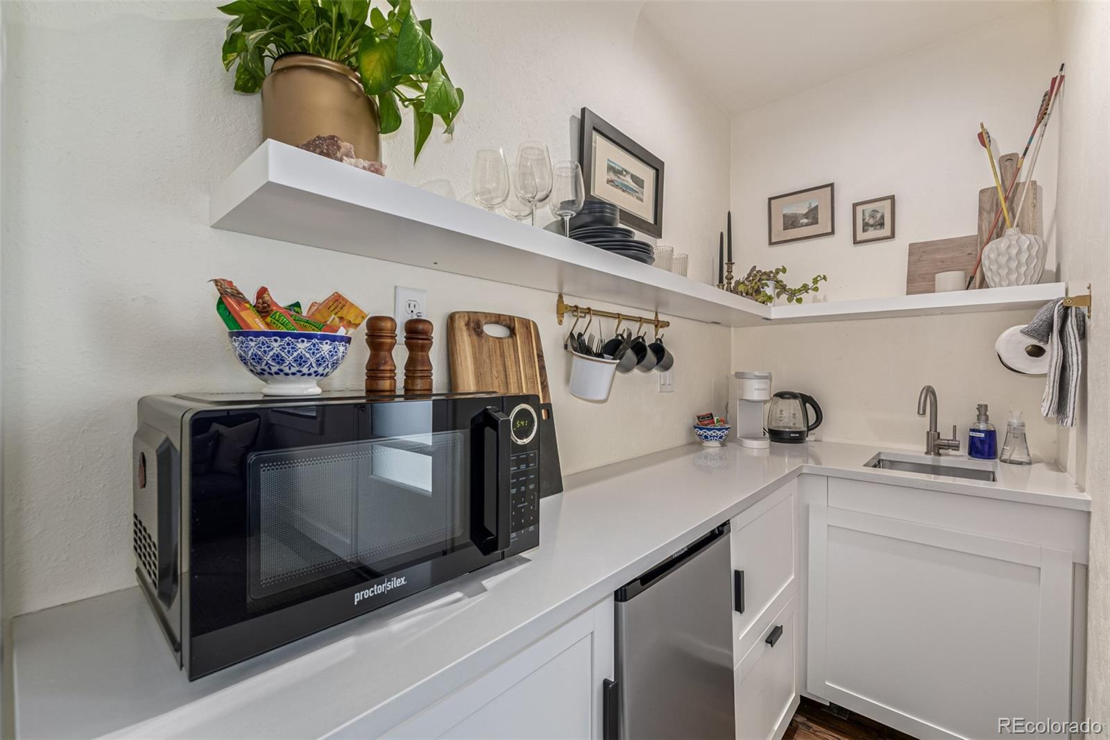 1227 Elm Street Denver, CO 80220 - Photo 23 of 44 a utility room with stainless steel appliances a sink and cabinets