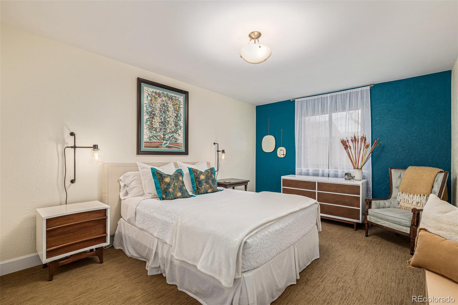 1227 Elm Street Denver, CO 80220 - Photo 27 of 44 a bedroom with a bed and a chandelier