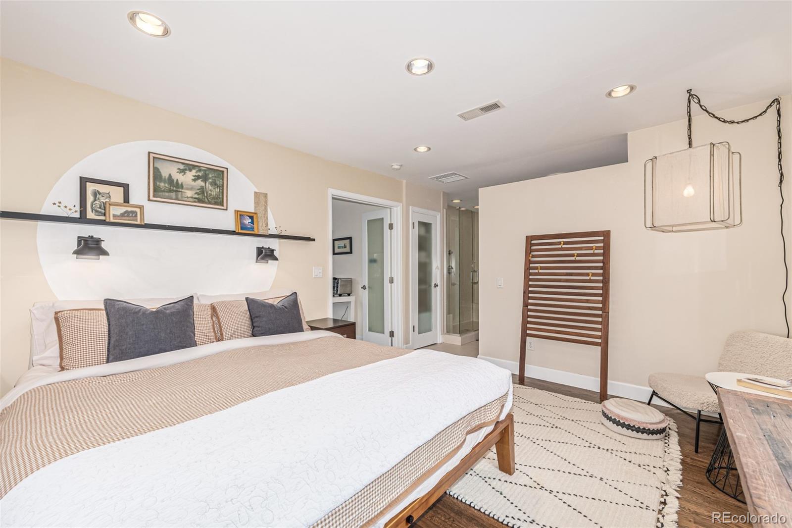 1227 Elm Street Denver, CO 80220 - Photo 32 of 44 a bedroom with a bed and a night stand