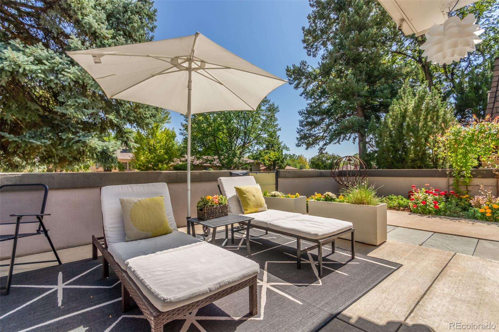 1227 Elm Street Denver, CO 80220 - Photo 41 of 44 a couple of chairs sitting in a roof deck with umbrella