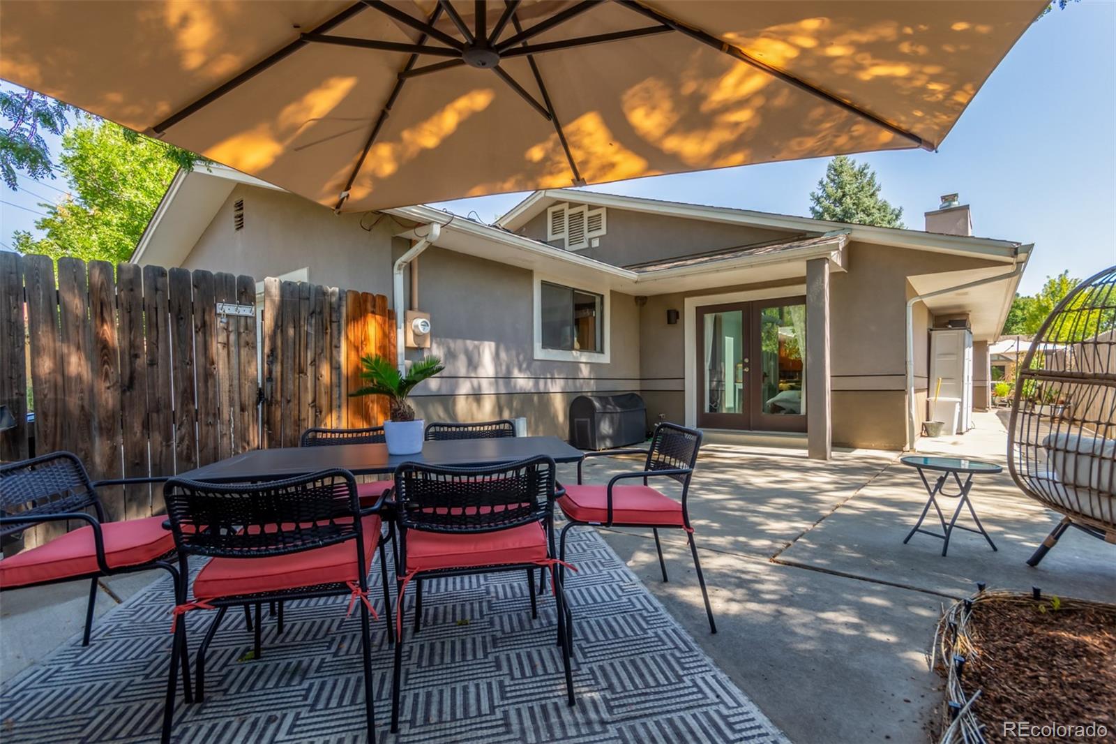 1227 Elm Street Denver, CO 80220 - Photo 42 of 44 a view of a dinning tables and chairs in patio of the house