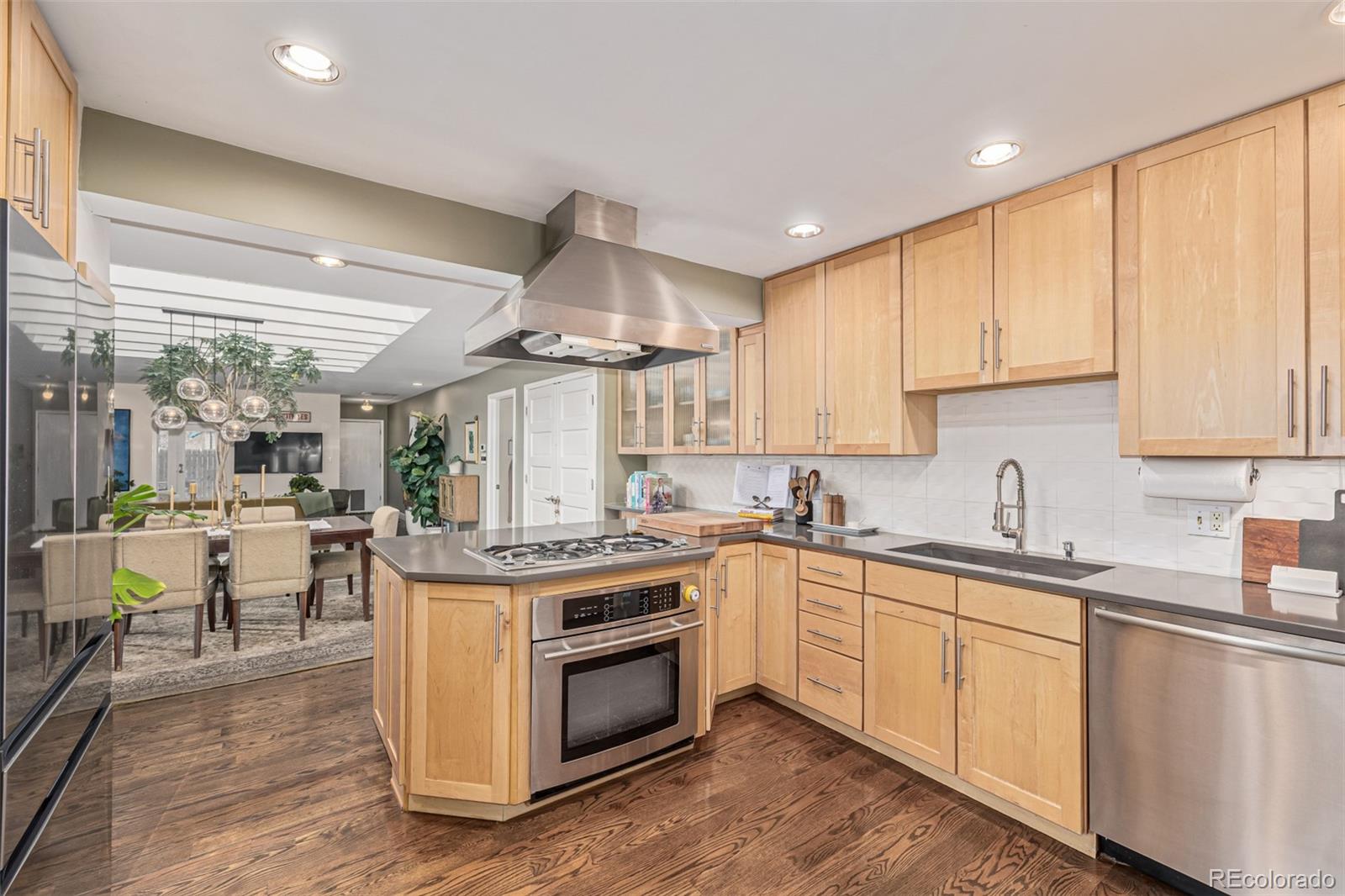 1227 Elm Street Denver, CO 80220 - Photo 10 of 44 a kitchen with a stove top oven sink and cabinets