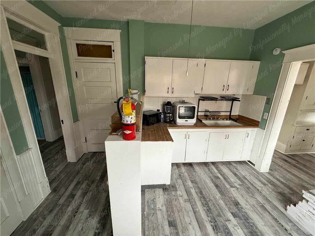 44 West High Street, Unit D Springfield, OH 45502 - Photo 17 of 25 This cozy kitchen features functional cabinetry and durable flooring, perfect for everyday living.