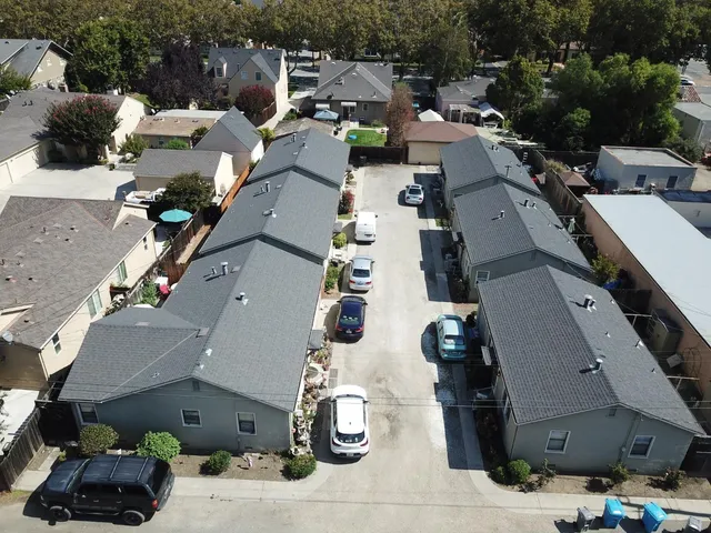 an aerial view of multiple houses with yard