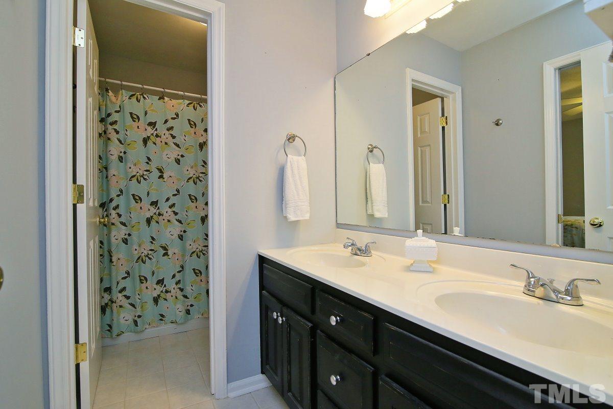 5649 Hamstead Crossing Raleigh, NC 27612 - Photo 15 of 25 a bathroom with a sink and a mirror