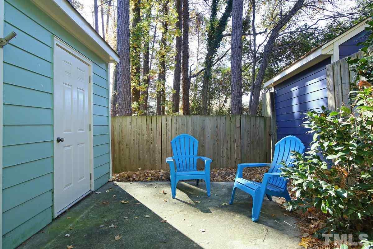 5649 Hamstead Crossing Raleigh, NC 27612 - Photo 19 of 25 a view of a backyard with furniture and a fire pit