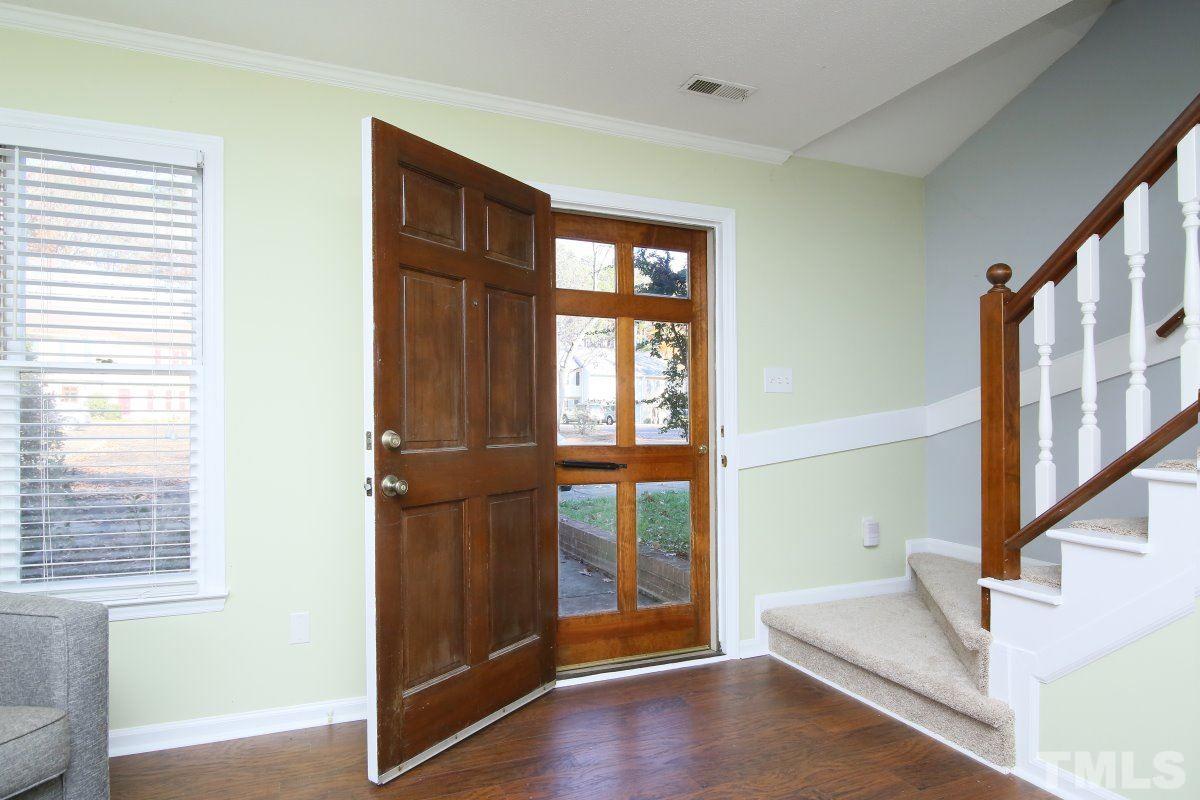 5649 Hamstead Crossing Raleigh, NC 27612 - Photo 3 of 25 a view of an entryway with wooden floor and door