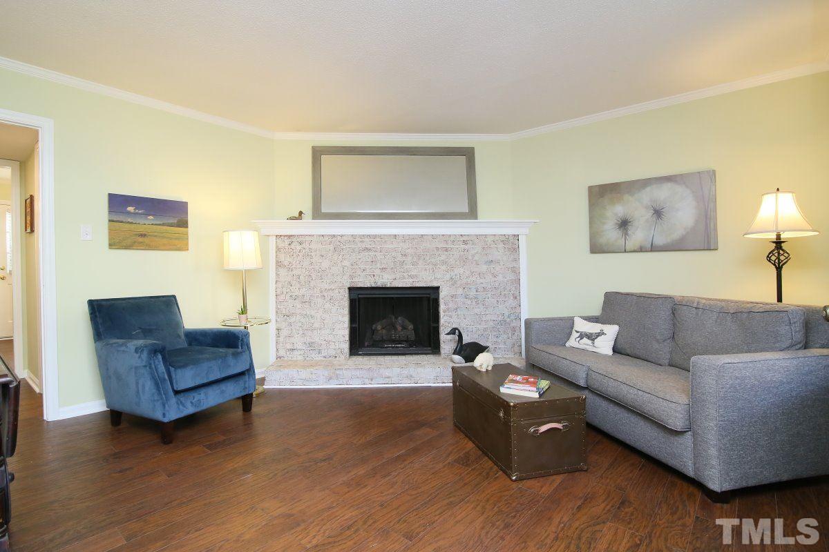 5649 Hamstead Crossing Raleigh, NC 27612 - Photo 4 of 25 a living room with furniture and a fireplace