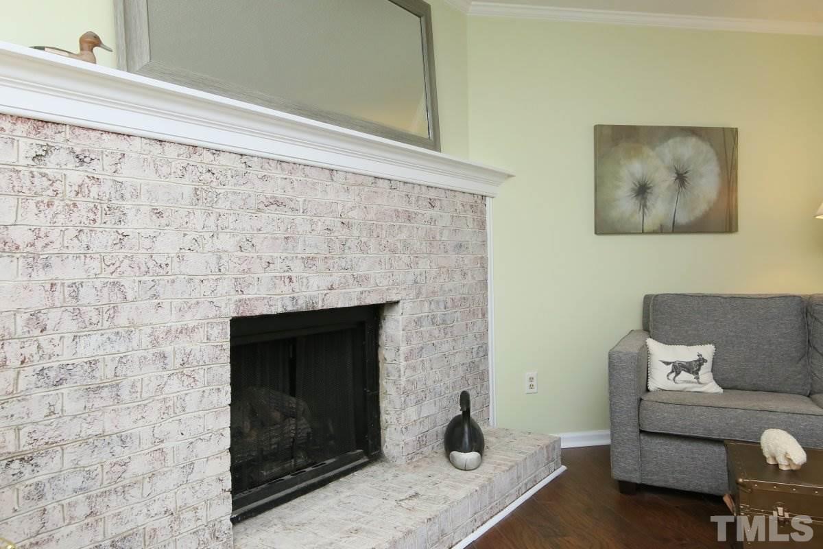 5649 Hamstead Crossing Raleigh, NC 27612 - Photo 5 of 25 a living room with a couch and a fireplace