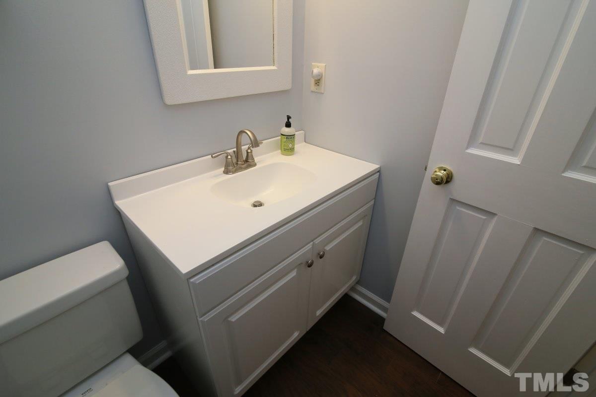 5649 Hamstead Crossing Raleigh, NC 27612 - Photo 6 of 25 a close up of a sink and a mirror
