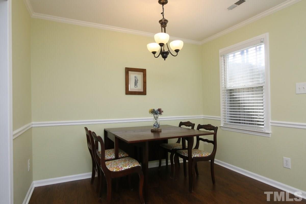 5649 Hamstead Crossing Raleigh, NC 27612 - Photo 10 of 25 a view of a dining room with a table and chairs