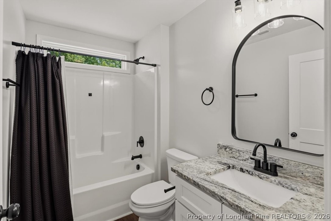 170 Starlight Road Lillington, NC 27546 - Photo 28 of 37 a bathroom with a granite countertop sink toilet and shower