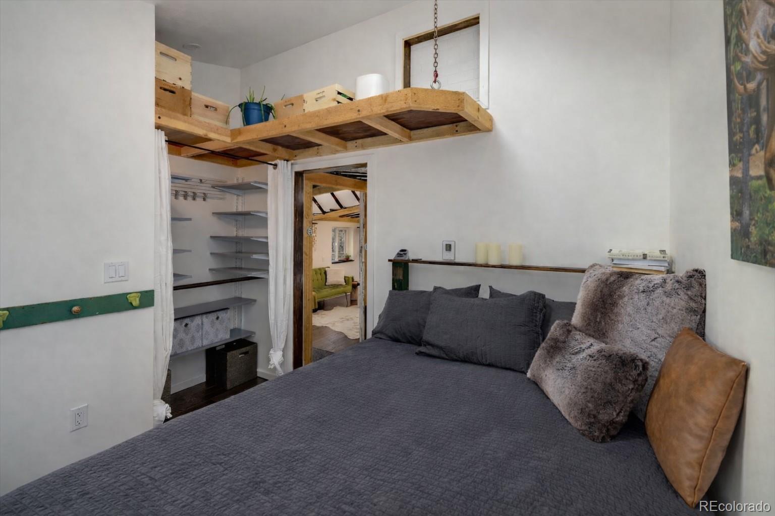 24 Signal Rock Road Golden, CO 80403 - Photo 13 of 26 a bed room with a bed and a fireplace