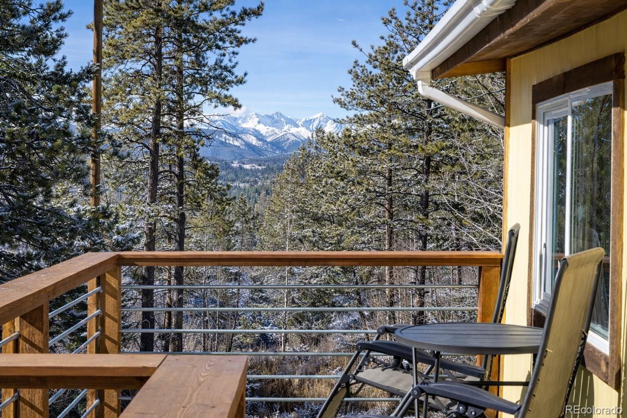 24 Signal Rock Road Golden, CO 80403 - Photo 23 of 26 a view of a balcony with wooden floor and outdoor seating