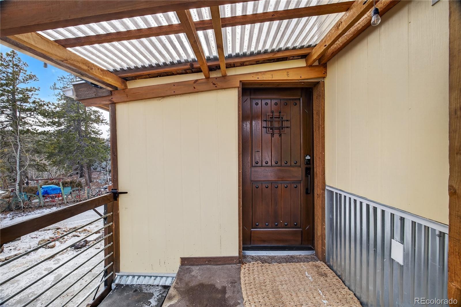 24 Signal Rock Road Golden, CO 80403 - Photo 4 of 26 a view of a porch with a table and chairs