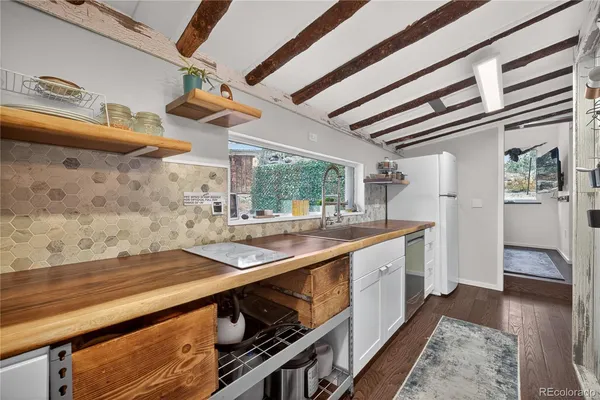 a kitchen with stainless steel appliances granite countertop a sink and stove