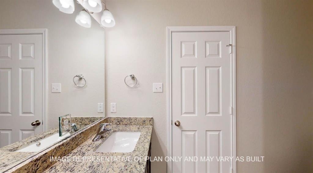 10113 Neptune Court Waco, TX 76708 - Photo 18 of 24 Bathroom vanity with a white rectangular undermount sink, a chrome-finish faucet, and a polished stone countertop