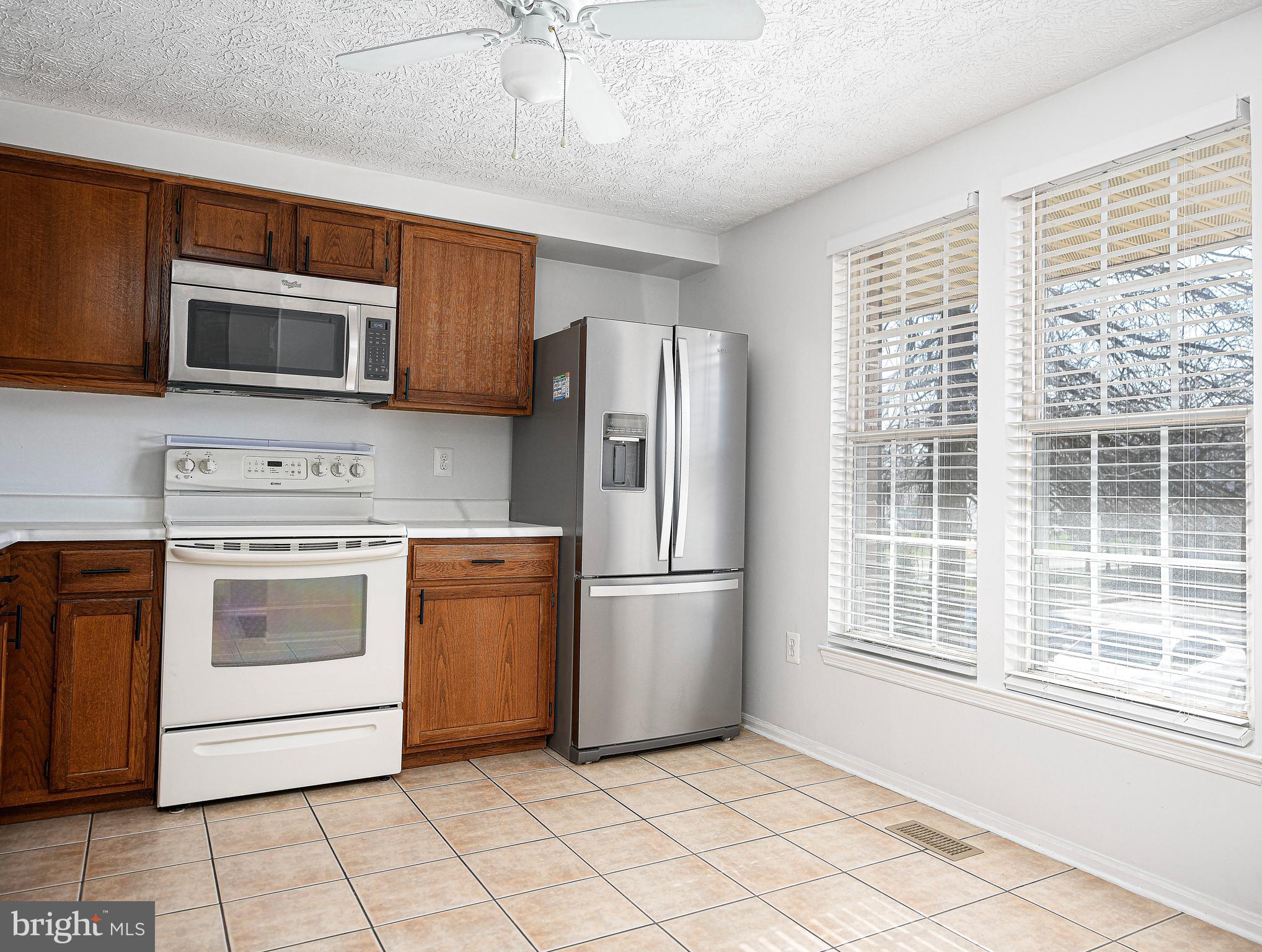 3702 Timahoe Circle Baltimore, MD 21236 - Photo 3 of 34 a kitchen with stainless steel appliances granite countertop a refrigerator and a stove top oven