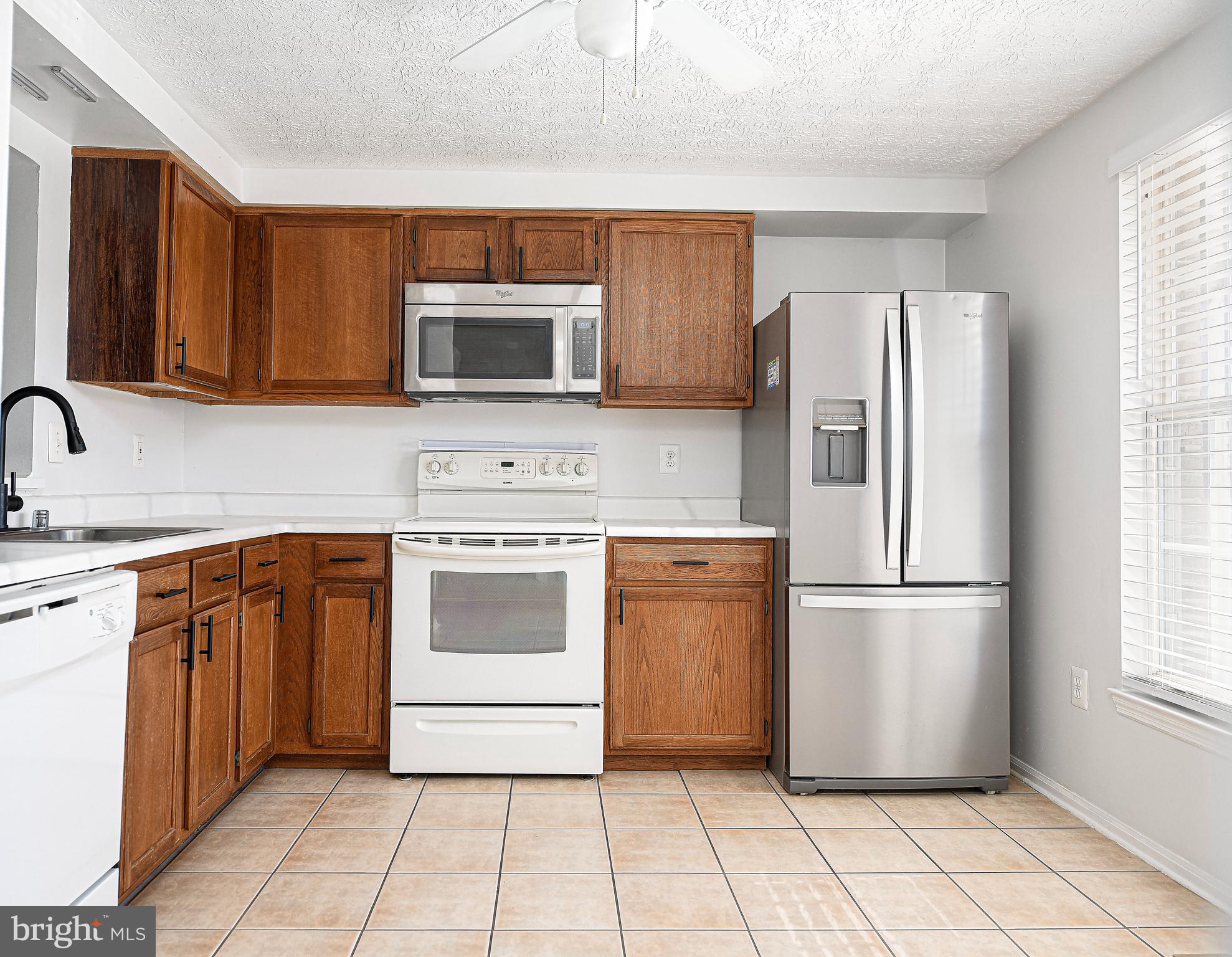 3702 Timahoe Circle Baltimore, MD 21236 - Photo 6 of 34 a kitchen with stainless steel appliances granite countertop a refrigerator and a stove top oven