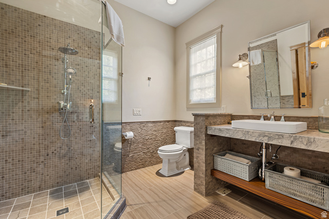 105 River Bend Circle, Unit 105 Springdale, UT 84767 - Photo 17 of 56 Glass-enclosed shower featuring mosaic tile surround and rain showerhead