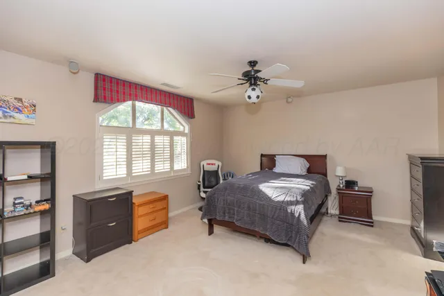 an empty room with chandelier and glass door